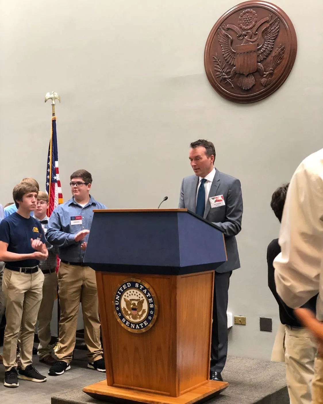 Students beside a podium with the congressional seal at Rockets on the Hill