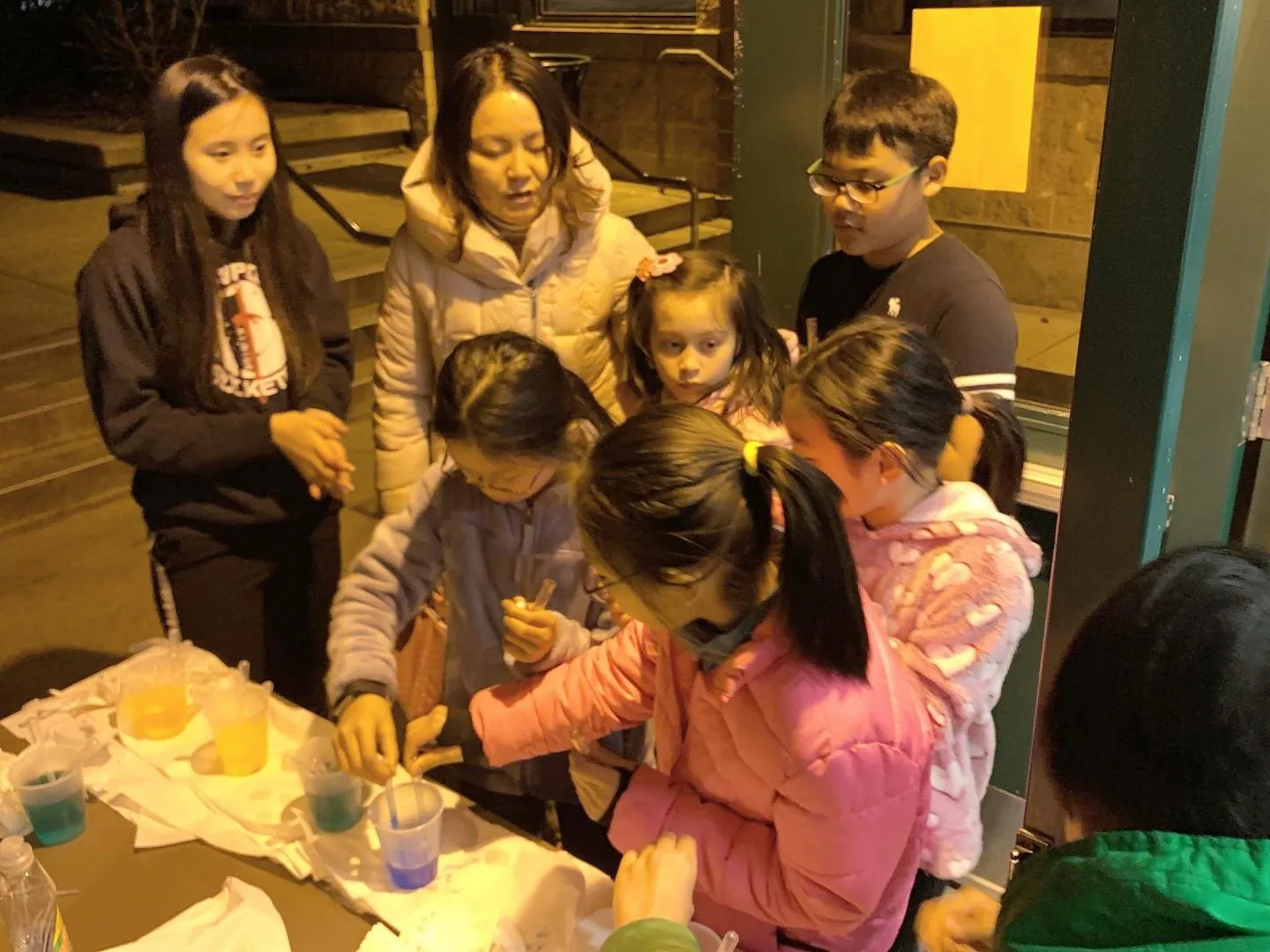 Elementary students gathered around a rocketry activity table