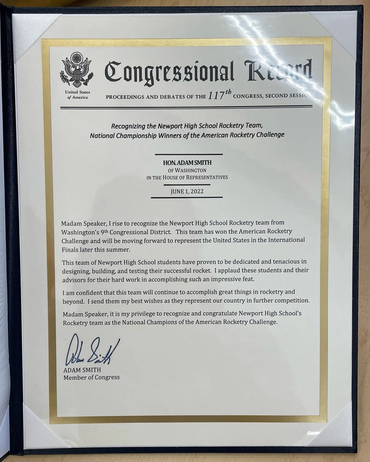 A framed Congressional Record recognizing the Newport rocketry team