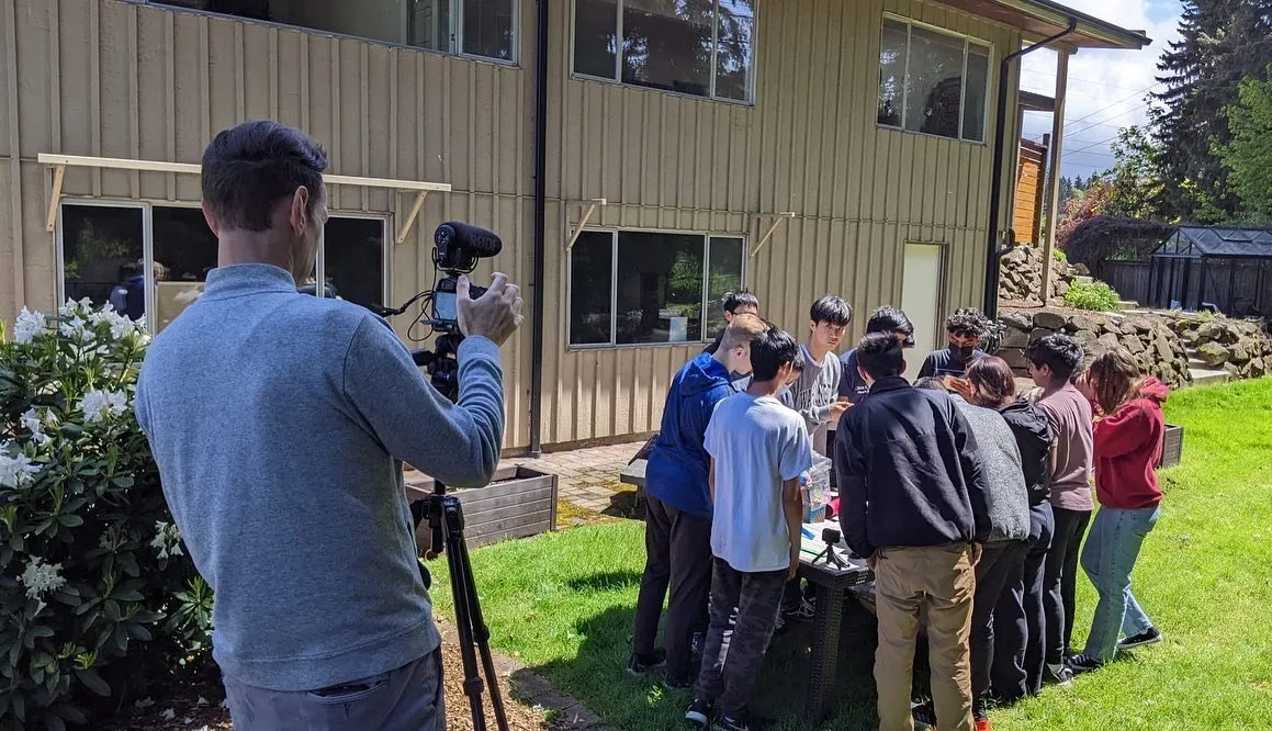 A TV camera filming the team for KING 5 news