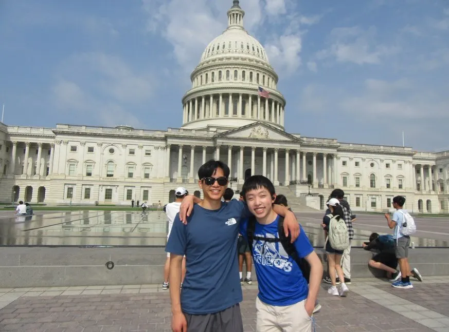 Two team members in front of the US Capitol