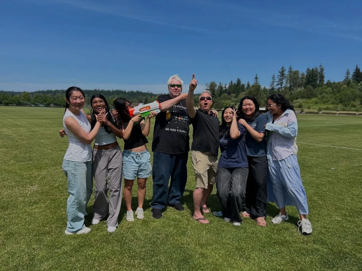 Club members celebrating on a sunny launch field