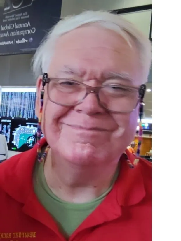 Bruce Buswell smiling in a red Newport Rocketry shirt